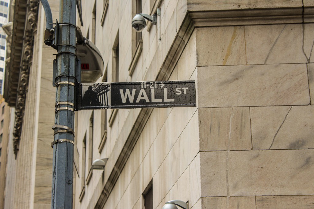 A picture of the Wall Street sign on a New York corner